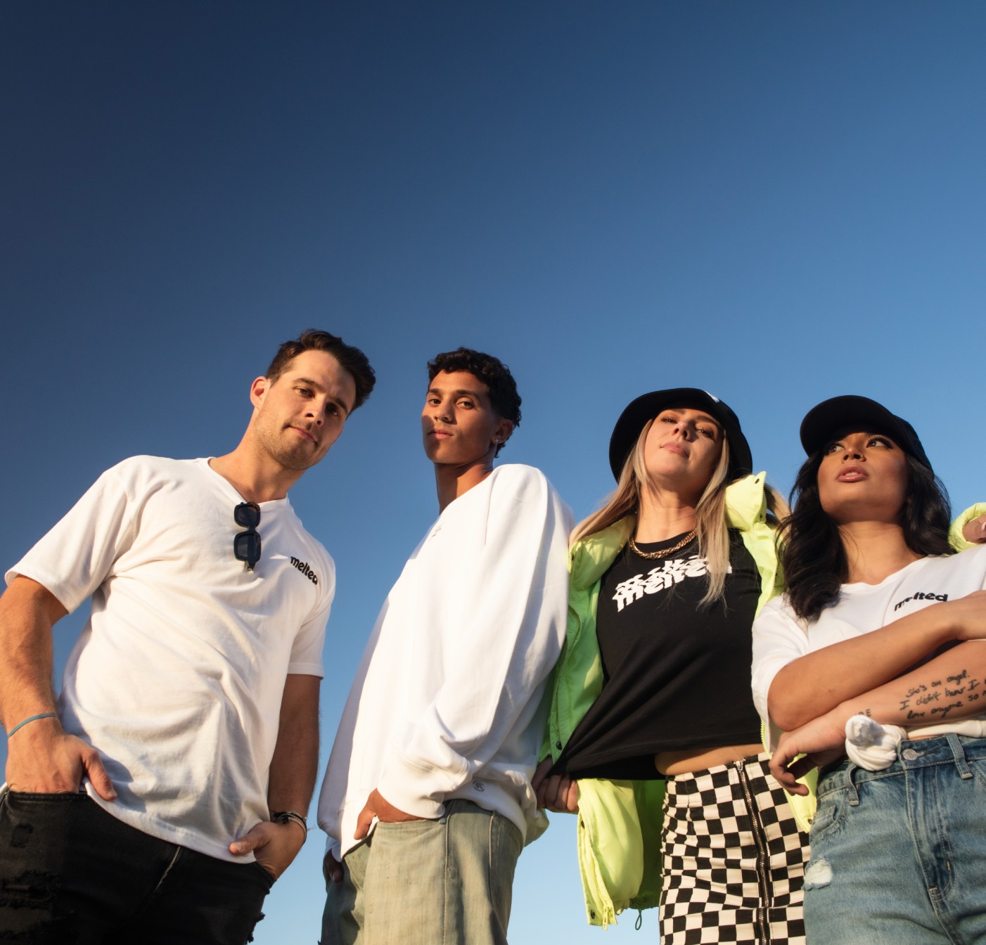 Four members of the Melted collective under an open sky